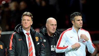 Manchester United manager Louis van Gaal, left, leaves the pitch with Manchester United's striker Robin van Persie after their English Premier League football match against Hull City at Old Trafford in Manchester, north west England, on November 29, 2014. Manchester United won the game 3-0. AFP PHOTO / OLI SCARFF