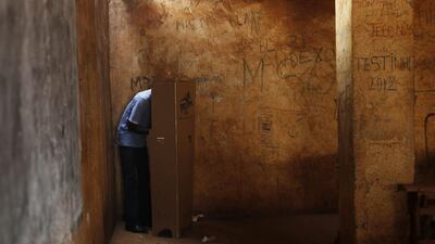 A man casts his ballot in the second round of presidential elections and the first round of legislative elections in the Fatima district of Bangui, Central African Republic. Two former prime ministers, Faustin Archange Touadera and Anicet Georges Dologuele, are running neck-and-neck in the second round of presidential elections to end years of violence pitting Muslims against Christians in the Central African Republic. Jerome Delay / AP
