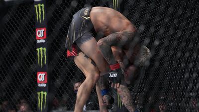 Charles Oliveira applies a hold against Dustin Poirier. Reuters