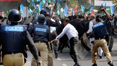 Pakistani policemen baton charge opposition party activists during an anti-government protest rally in Lahore.
