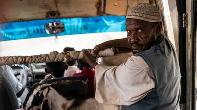Mohamed, 60, from Eritrea, rides on a bus with a goat to Shagarab refugee camp during the rainy season. More than 50,000 people have poured into Sudan since violence broke out between Ethiopian forces and the Tigray Peoples' Liberation Front in 2020. Getty