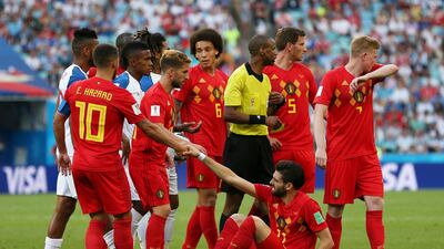 Eden Hazard helps teammate Yannick Carrasco to stand after he was fouled. Francois Nel / Getty Images