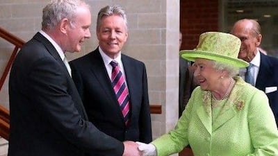 Britain's Queen Elizabeth II shakes hands with Northern Ireland deputy first minister Martin McGuinness (left), watched by first minister Peter Robinson and Prince Philip at the Lyric Theatre in Belfast, Northern Ireland.