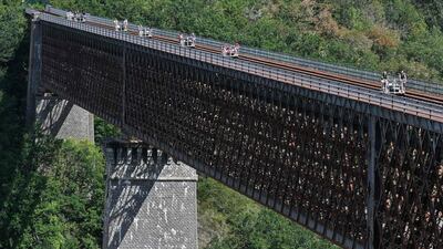 People cross the Viaduc des Fades as they ride the 'vélorail' on an old railway line in Les Ancizes-Comps central France. AFP