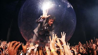 Wayne Coyne is held aloft by the crowd inside an inflatable bubble at one of The Flaming Lips' performances.