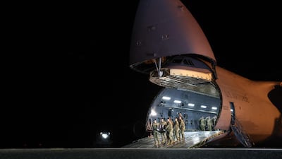 US military personnel at Dover Air Force Base carry the remains of an officer killed in the Iran war. AFP