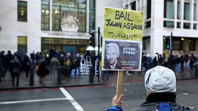 A Julian Assange supporter outside Westminster Magistrates Court as his bail hearing is held at the court in Londo. AP Photo