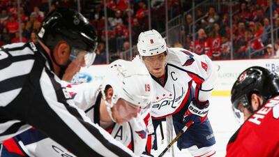 A referee prepares to drop the puck for a face-off during the NHL game between the Washington Capitals and New Jersey Devils last week. Al Bello / Getty Images / AFP / March 25, 2016
