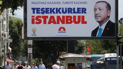 People walk past a poster for Turkey's President Tayyip Erdogan in Istanbul, Turkey, June 25, 2018. The poster reads: 'Our people won, Turkey won, Thank you istanbul'. Osman Orsal / Reuters Photo