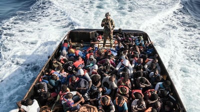 A Libyan coast guardsman watches over the rescue of 147 illegal immigrants attempting to reach Europe off the coastal town of Zawiyah, 45 kilometres west of the capital Tripoli. Taha Jawashi / AFP Photo / June 27, 2017