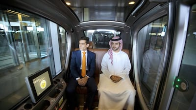 Professor Karim Karam, left, professor of engineering systems management, and Hamad Al Raqbani, research engineer, in a driverless vehicle at the Masdar Institute in Abu Dhabi. Christopher Pike / The National