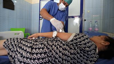 A hospital staff treats a patient inside the hospital of Boufarik, Algeria, 26 August 2018. EPA