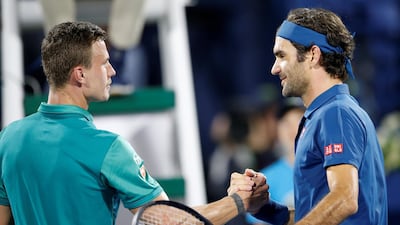 Federer is greeted by Fucsovics after winning their quarter-final match. EPA