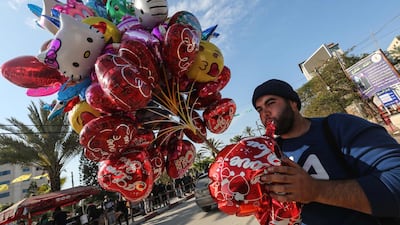 A Palestinian man sells ballons ahead of New Year's celebrations in Gaza City. AFP