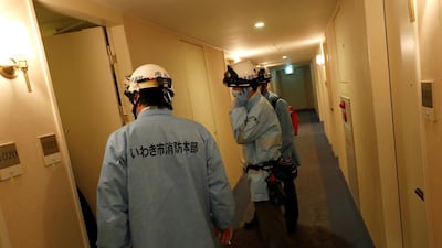 Ambulance crew members stand in the hotel corridor following a strong earthquake in Iwaki, Fukushima prefecture, Japan February 13, 2021. REUTERS