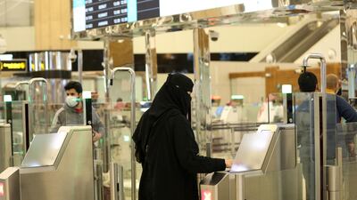 A Saudi woman scans her documents at the digital immigration gate at the King Khalid International Airport in Riyadh. Reuters