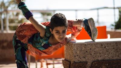 Mohammed Al Sheikh is only 12 years old and feels trapped in Gaza. Still, he dreams of a Guinness world record for his almost unbelievable body contortions and stunning backflips. Mahmud Hams / AFP