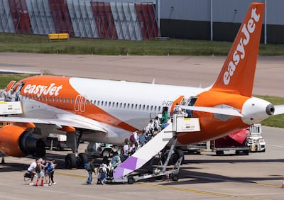 Passengers board an easyJet aircraft at Luton Airport. Chief executive Johan Lundgren said that without ancillary pricing underlying fares would increase. Bloomberg