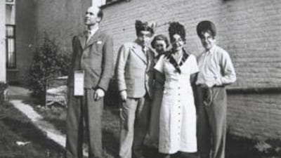 Rene Magritte with friends in the garden of his Brussels home.