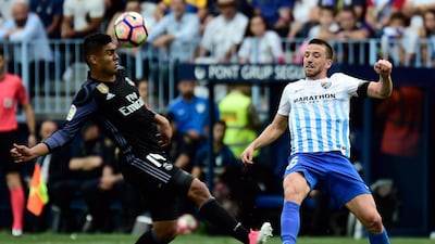 Real Madrid’s Brazilian midfielder Casemiro, left, vies with Malaga defender Ignacio Camacho. Jose Jordan / AFP
