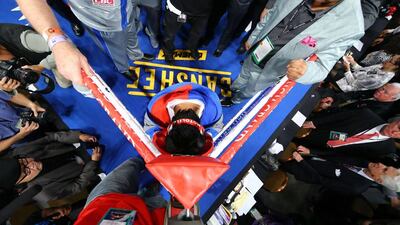 Manny Pacquiao prays in the ring before taking against Juan Manuel Marquez. Al Bello / Getty Images