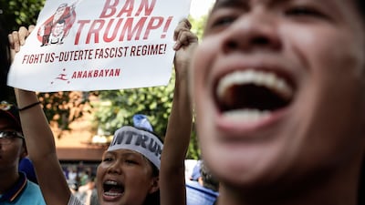 Not such a warm welcome for Donald Trump outside the US embassy as he arrives for two days of summits in the Phillippines on November 12, 2017. Mark R. Cristino