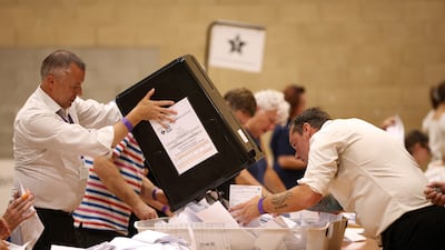 Election workers review ballots after voting closed. The by-election was boycotted by the major political parties. Getty Images
