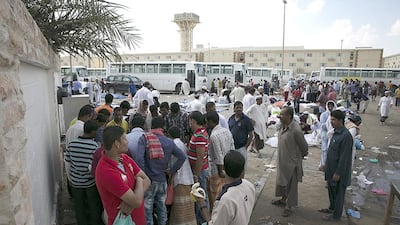 Men watch a gambling game at a local makeshift market at Al Mafraq Workers City 2, near Baniyas and Abu Dhabi, on Friday, Nov 22, 2013. Silvia Razgova / The National