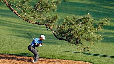 Tiger Woods tries to bail himself out on the 17th fairway during the third round. Hans Deryk / Reuters