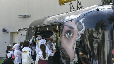 People line up for food at one of the food trucks on the festival grounds.