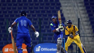 Shahzad Manna of Yogi Group, centre, plays a shot against Danube Lions. The two teams hold Bukhatir League in high esteem. Satish Kumar / The National
