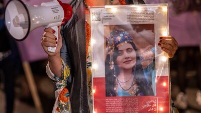 A demonstrator holds a picture of Mahsa Amini during a protest march on Friday night in Berlin, Germany. Getty Images