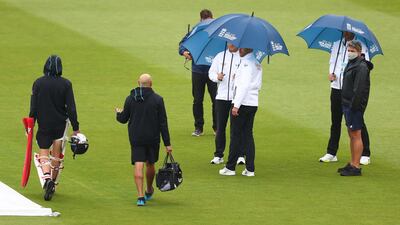 Umpires Mike Burns, Richard Kettleborough and Michael Gough speak to MCC Head Groundsman Karl McDermott and Trent Boult of New Zealand during an inspection as play is delayed due to rain. Getty Images