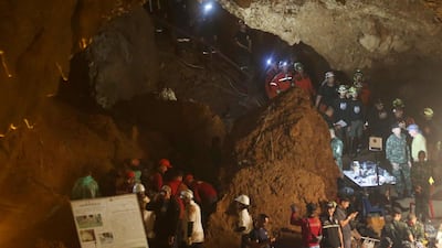 Emergency rescue teams gather in the staging area as they continue the search for 12 young footballers and their coach after going missing in a large cave in Mae Sai, Chiang Rai province, in northern Thailand. Sakchai Lalit / AP Photo