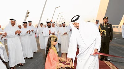 The late president Sheikh Khalifa returns a pair of scissors he used to cut the ceremonial ribbon symbolising the formal opening of the Sheikh Zayed Bridge in Abu Dhabi, on November 28, 2010. Photo: Wam