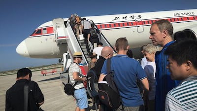 Passengers board an Air Koryo plane at the Pyongyang International Airport. It has been ranked the world’s worst airline for four straight years by SkyTrax. Wong Maye E / AP Photo