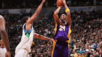 Kobe Bryant, right, of the Los Angeles Lakers takes a shot against the Minnesota Timberwolves.