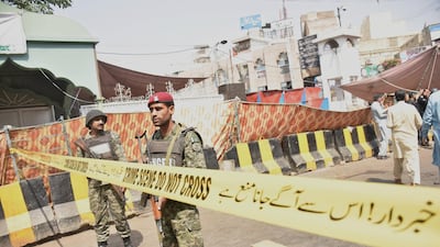 Pakistani security officials inspect the scene of a suicide bomb attack that targeted a police vehicle outside the Sufi Muslim Data Gunj Buksh shrine in Lahore. EPA