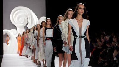 Models walk in the finale of the Carolina Herrera Spring 2013 collection, during Fashion Week in New York, Monday, Sept. 10, 2012. (AP Photo/Richard Drew)