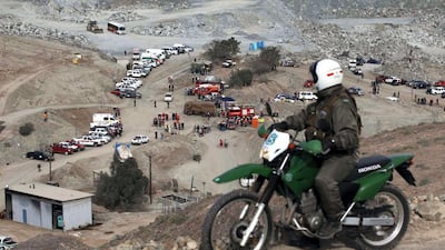 A policeman stands guard on a hill in front of a copper and gold mine where 33 miners are trapped in Copiapo, August 6, 2010. Rescuers struggled on Friday to reach the miners trapped in the small mine in northern Chile after a cave-in a day earlier, hoping miners took refuge in an underground shelter with oxygen and water. REUTERS