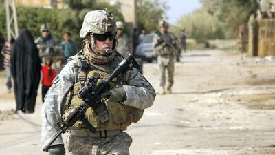 A US soldier stands guard near a school in the town of Iskandiriyah in Iraq's Babel province, 45 kms south of Baghdad, Iraq. AFP