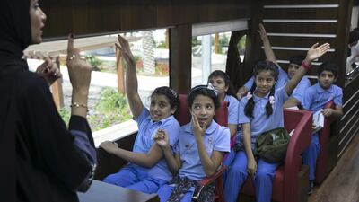 Pupils are briefed on the role of the notary public, legal aid and public prosecution in the mobile court bus. Silvia Razgova / The National