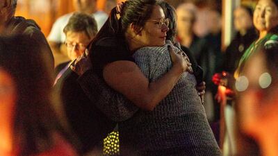 People embrace during a vigil in honour of the victims of a mass stabbing incident, in Prince Albert, Saskatchewan. AP