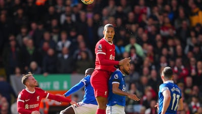 Liverpool's Virgil van Dijk, centre, heads the ball during the English Premier League soccer match between Liverpool and Everton. AP