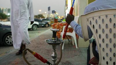 A man smoking shisha at a coffee shops in Ajman. Satish Kumar / The National
