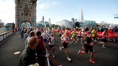 Spectators watch runners during the London Marathon as they run over Tower Bridge. Reuters