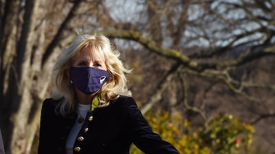 Jill Biden, wearing a military-style coat, walks across the South Lawn to the White House on March 21, 2021. AFP