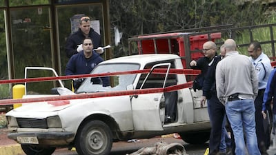 Israeli security inspect the scene of shooting near the settlement of Kiryat Arba in the West Bank, where two Palestinians on March 14, 2016, allegedly opened fire on pedestrians at a bus stop. Mahmoud Illean / Associated Press