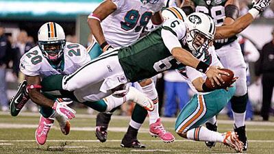 Mark Sanchez, the New York Jets quarterback, dives for a touchdown in his side's 24-6 win against the Miami Dolphins.