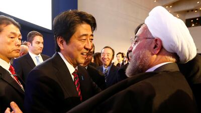 Japan's Prime Minister Shinzo Abe greets Iranian President Hassan Rouhani, right, during the 2014 meeting of the World Economic Forum in Davos. Reuters
